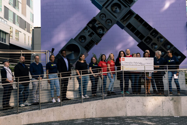 Wells Fargo presents a check to the Rise Together campaign